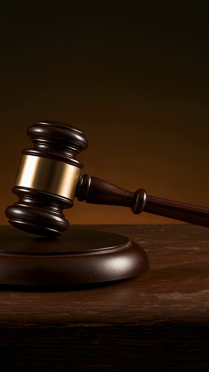 Vertical video: Shifting camera bringing gavel toward center on studio desk, revealing sound block