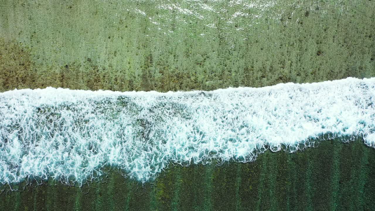 Rough waves crashing into the shoreline in Barbados captured from the air
