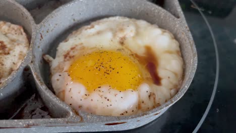 cooking eggs in pan on stove