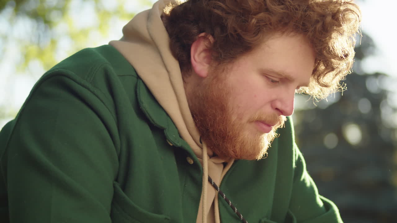 Man Petting and Feeding Dog in Park