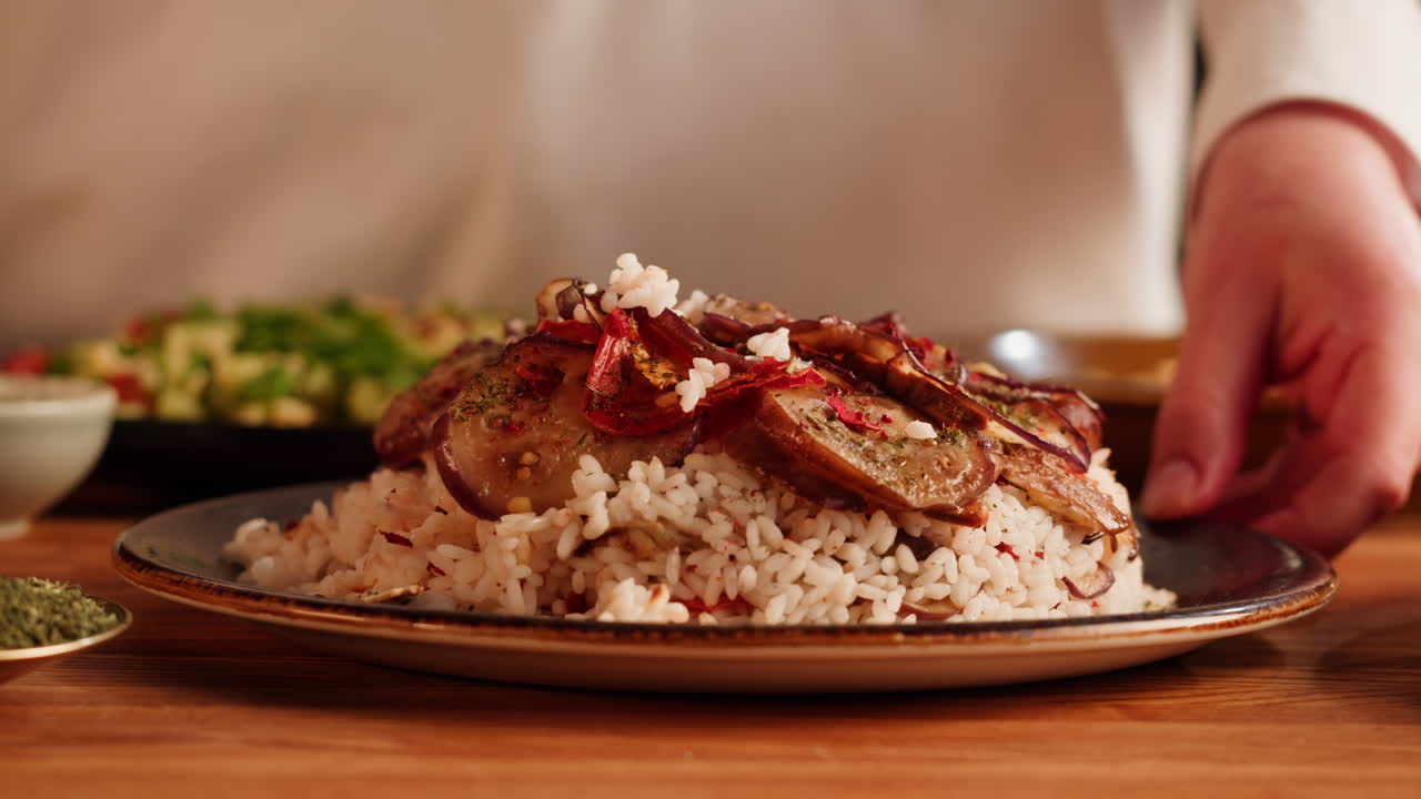 Chef preparing a delicious eggplant and rice dish