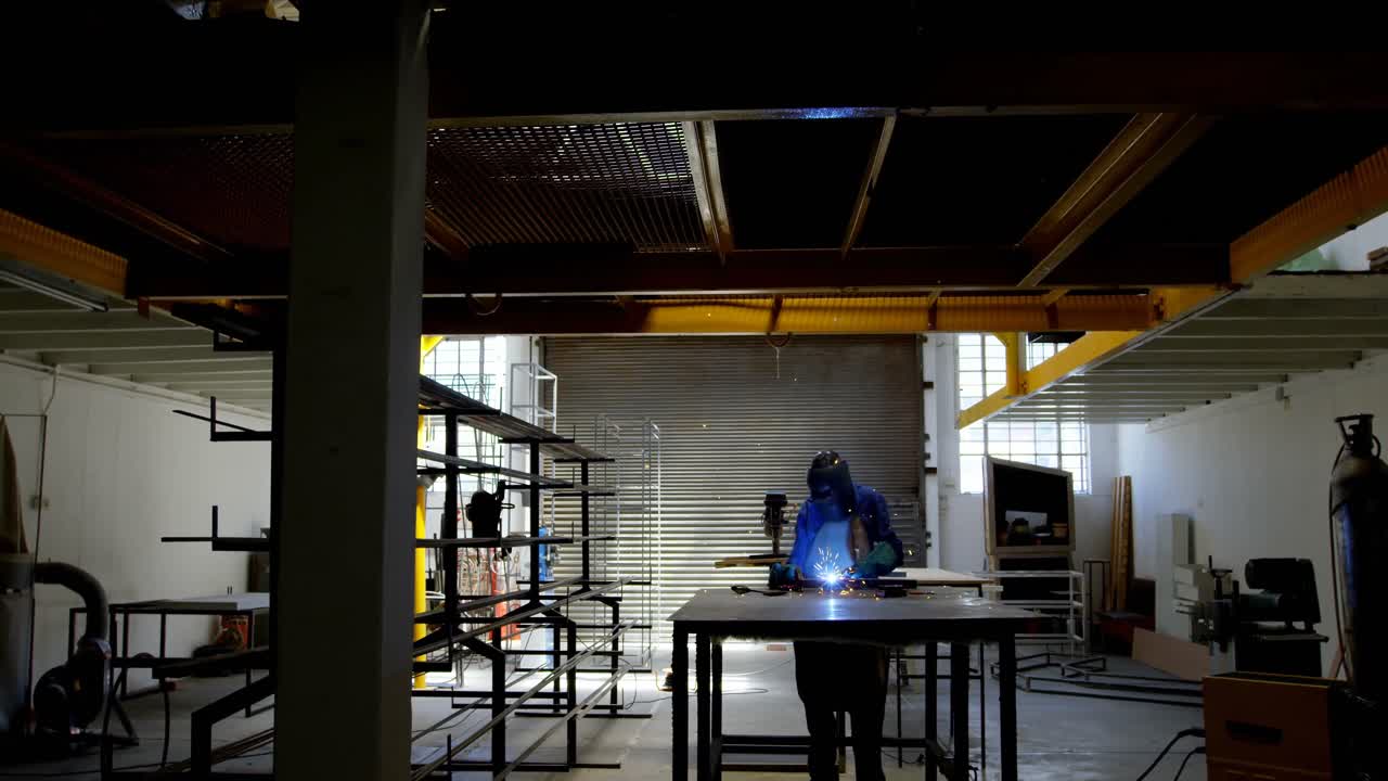 Female welder using blow torch on a rod 4k