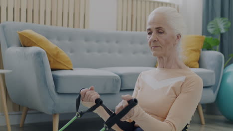 senior woman exercising with resistance bands at home