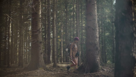 Woman-with-backpack-exploring-amidst-trees