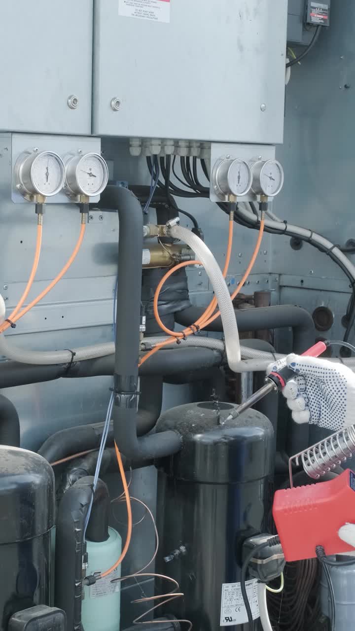 HVAC technician soldering pipes during maintenance