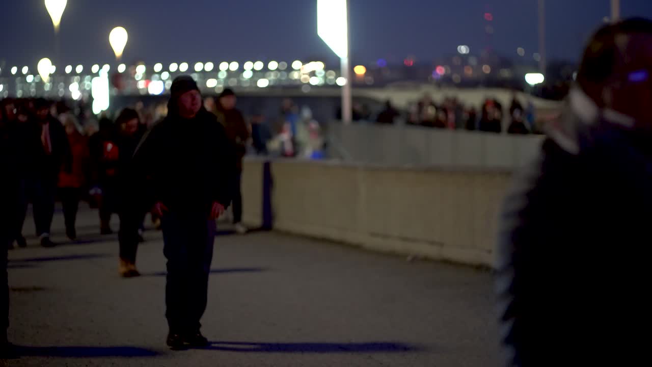 Crowed of fans walking to Allianz Arena during match day. Famous german soccer club FC Bayern Munich is playing a match. Fans are happy and exited.