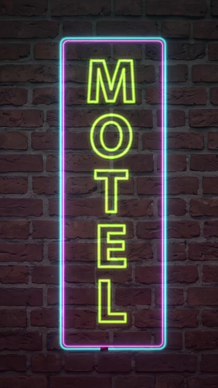 Texte de motel jaune lumineux à l'intérieur d'un cadre néon bleu scintillant sur un mur de fond en briques sombres