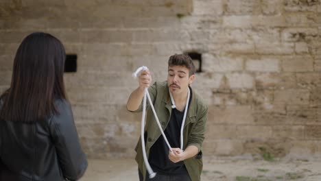 magician performing a rope trick outdoors