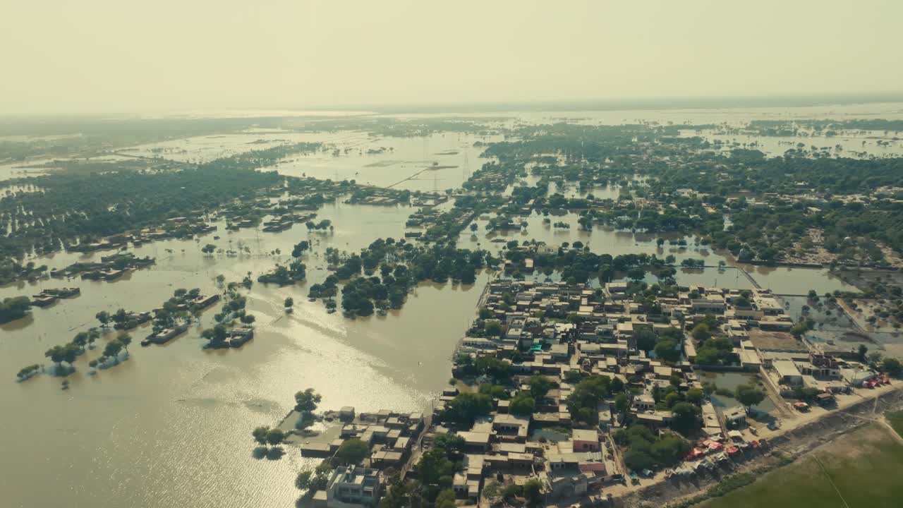 Aerial drone view of a town submerged by widespread, devastating floodwater