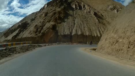 cruising on a bicycle at leh ladakh himalayas ghats pov shot