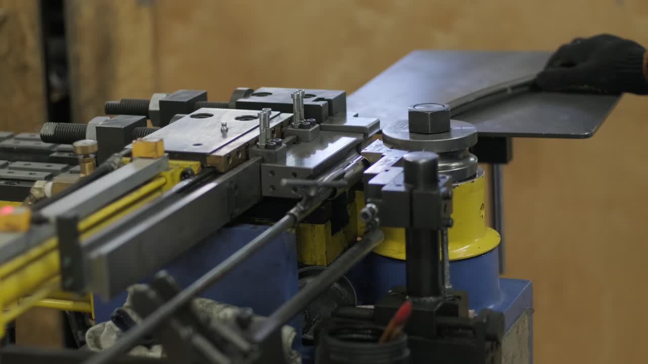 Industrial bender equipment machine for metal pipe bending in the factory. Automatic metalworking machine for electronic turning metal pipe and cold bending at industrial hall at manufacturing plant