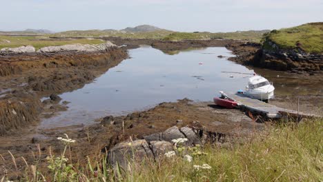 Shot-of-a-small-pleasure-boat-and-a-RHIB-lying-on-the-sea-floor-at-low-tide