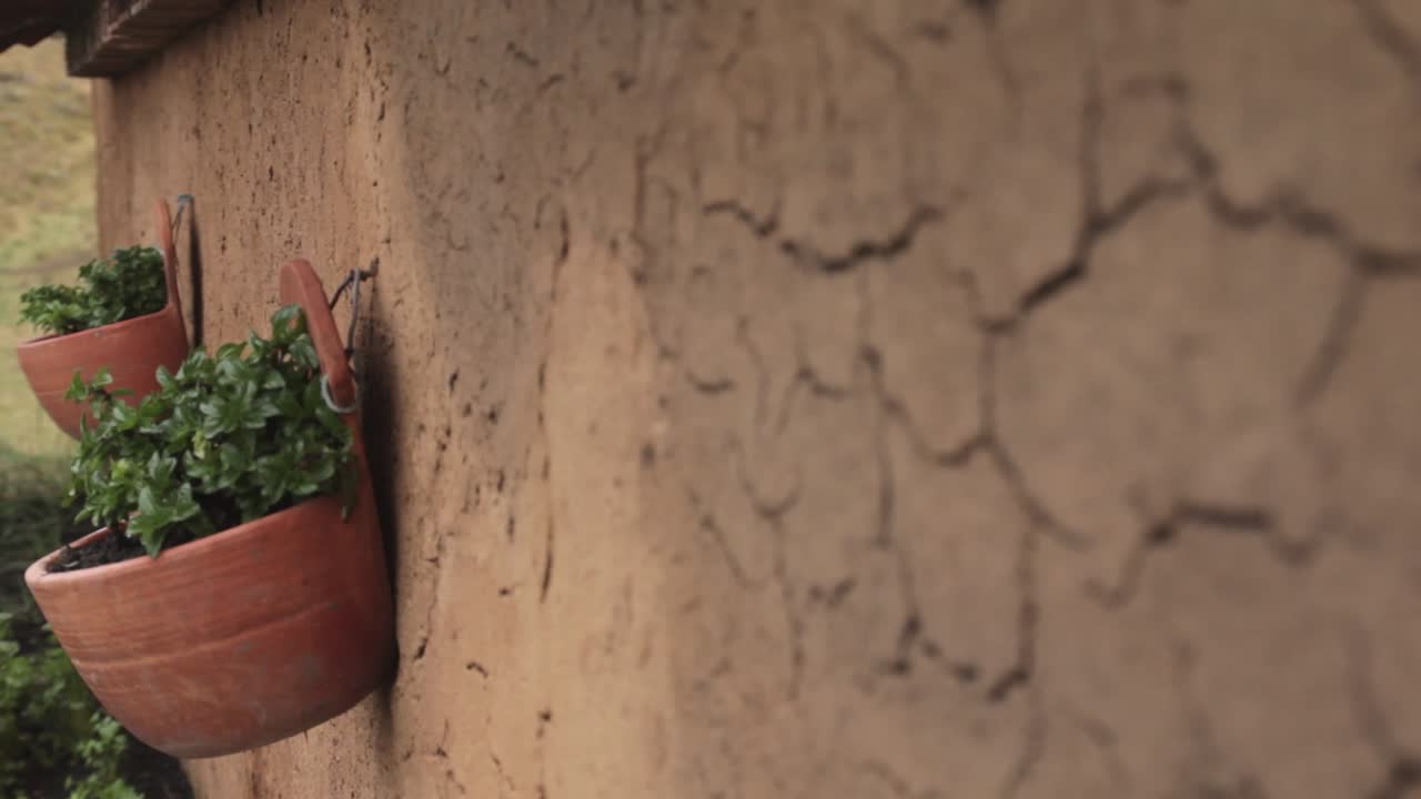 Pan left and rack focus over a rustic wattle and daub wall in a campesino house in El Cocuy National Park, Colombia