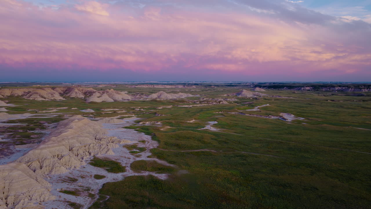 Rugged Badlands Terrain Bathed in Soft Golden Sunset Light from Above