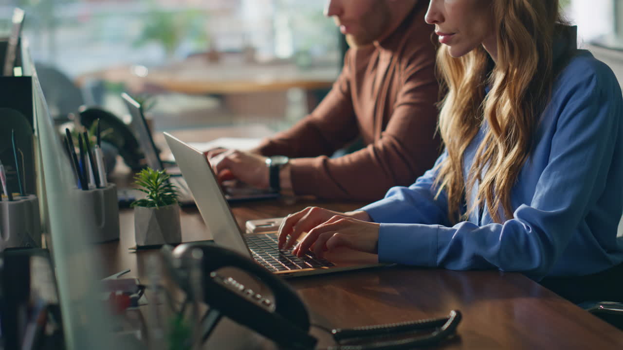 Busy employees working computers at office closeup. Two colleagues focused
