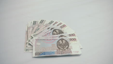 focus on: a lot of 500 polish zloty, lie on the center of white table