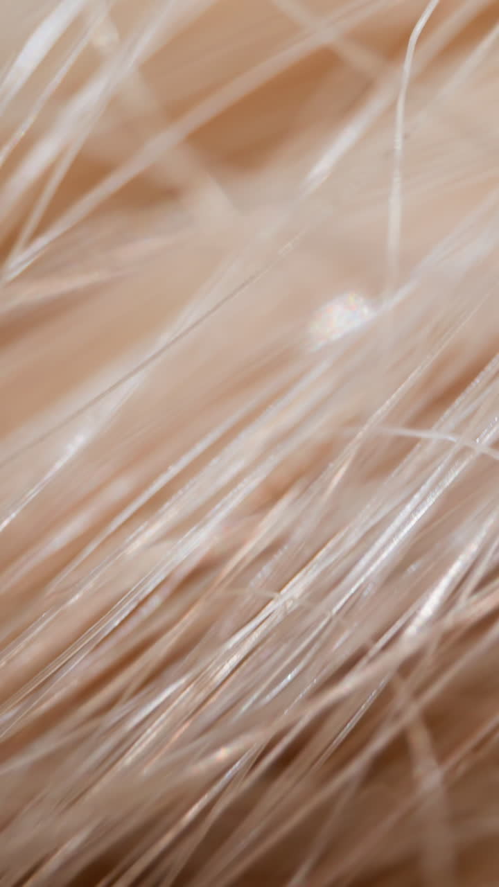Messy artificial bleached hair texture as background extreme closeup. Synthetic art material at studio illumination. Supplies for design and craft macro