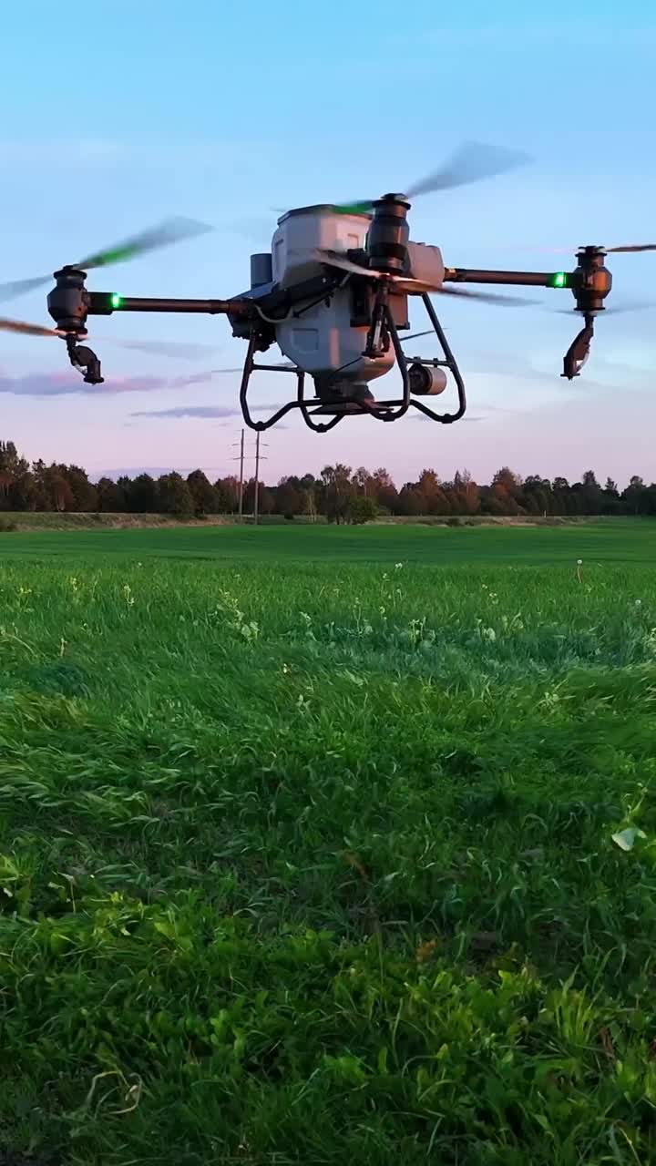 Drone flying over a green field