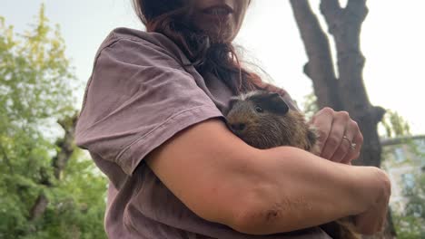 woman holding a guinea pig