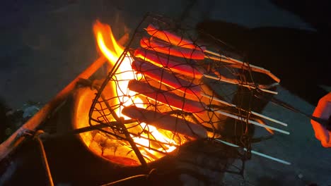 Skewered-sausages-are-grilled-on-fire