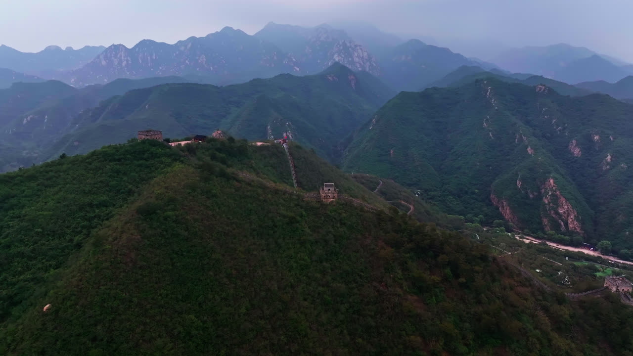 Aerial pan shot overlooking watchtower in the mountains of Great Wall, China