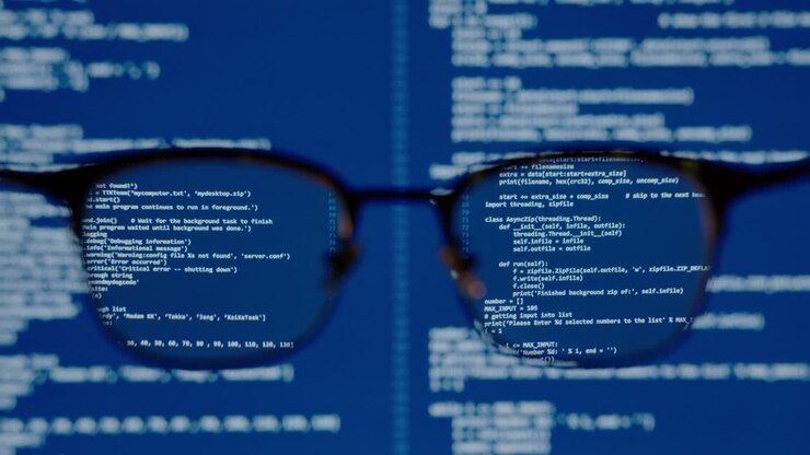 Coding on blue screen computer system thru eye glasses insight vision in data scientist programming ai for machine learning operation, modeling predictive analytics, data engineering IT skill concept.