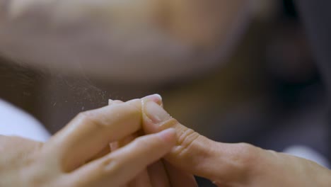 nails getting done with a file in a professional manicure session at the beauty salon