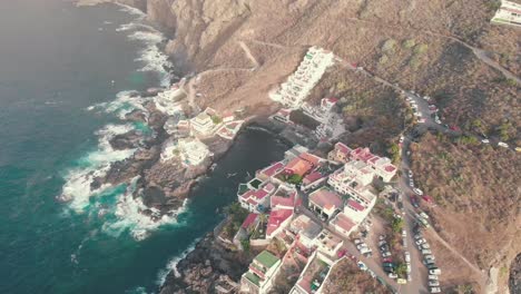 overhead view of waves splash on rocks