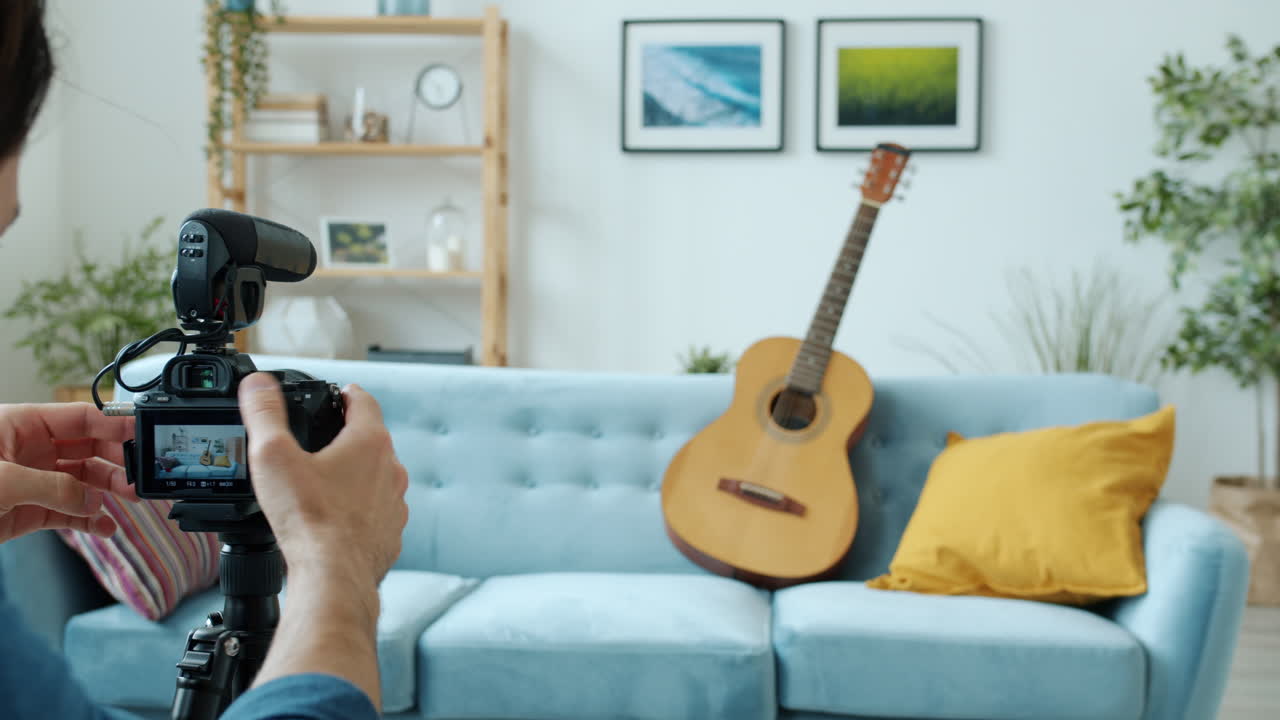 Musician recording video tutorial of playing guitar at home
