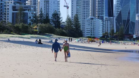 two people walking together on a sunny beach