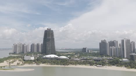 drone shot of forest city skyscrapers and coastline under a bright sky in johor bahru, malaysia