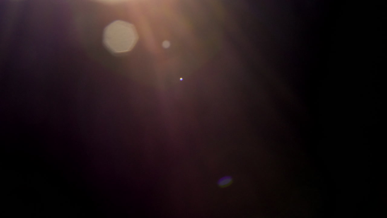 Warm lens flares on black background