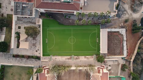 overhead view of an empty football pitch in malaga spain in the midst of residential buildings