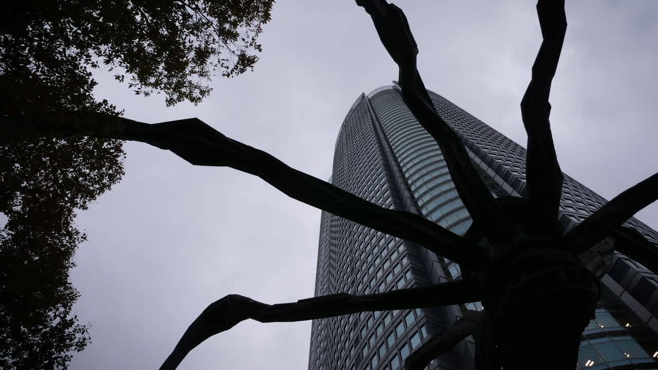 Time lapse, tilt, shot, of a skyscrapers, at the Roppongi hills area, on a cloudy day, in Japan