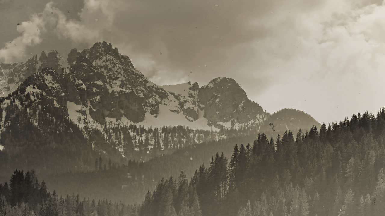 Vintage scratched footage of a mountain landscape, location: Dolomites, South Tyrol, Italy, 4k timel-apse