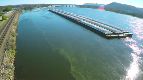 a very good aerial of a large coal barge going up the mississippi river