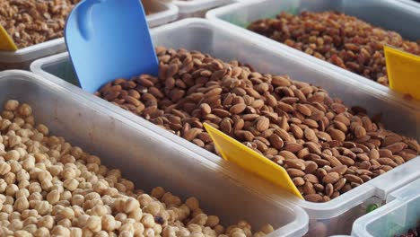 assorted nuts and dried fruits at a market stall