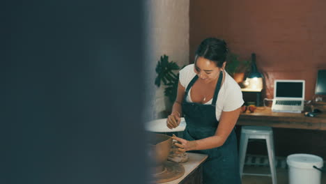 a young man and woman working with clay