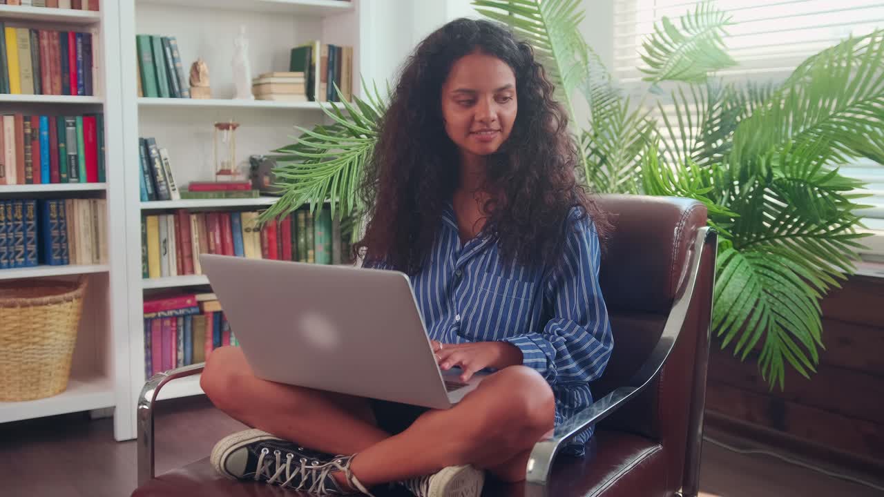 Indian teen girl shopping online browsing web pages and checking social media