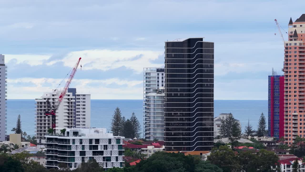 Aerial time-lapse of skyscraper construction in Gold Coast, Australia, showcasing changing skyline and dynamic urban development