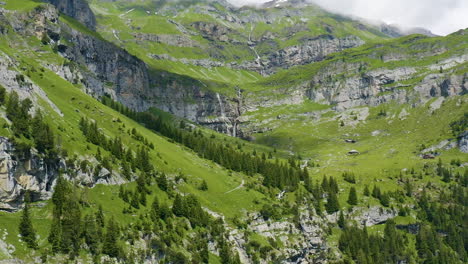 Beautiful-aerial-overview-of-stunning-Swiss-landscape-with-green-hills,-forests-and-mountains