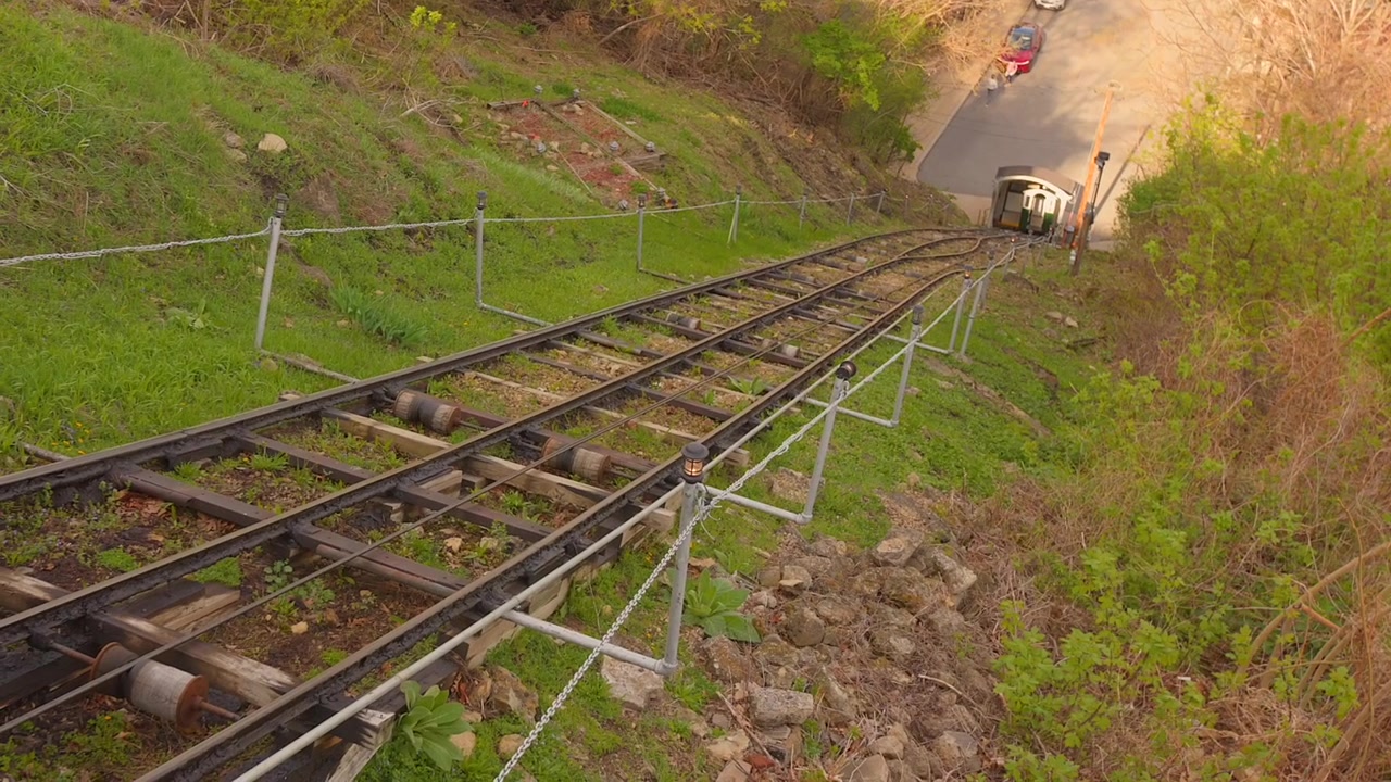 Historic Fenelon Place Elevator funicular railway tracks stretching up a steep green hillside in Dubuque, Iowa, known as the world's shortest and steepest railway.