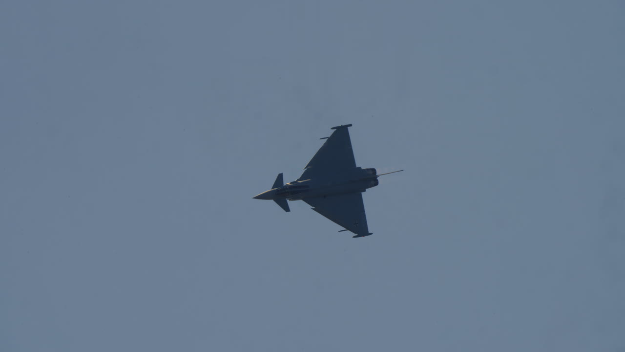 Eurofighter Typhoon Military Jet Maneuvering in Clear Blue Sky