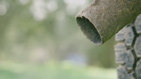 CLOSE-UP-old-car-exhaust-tailpipe-as-the-car-engine-starts