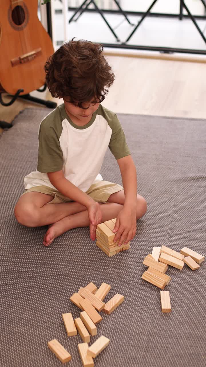 Young child playing wooden block game at home
