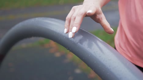 woman holding rail performing mobility balancing exercise