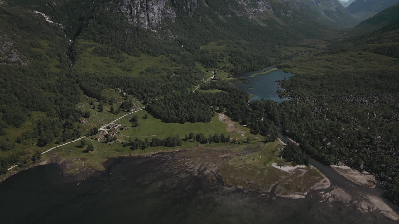 Majestic Mountains And Blue Lake In Innerdalen Norway - aerial pull out shot