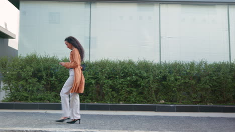 happy, walking and woman with a phone in the city