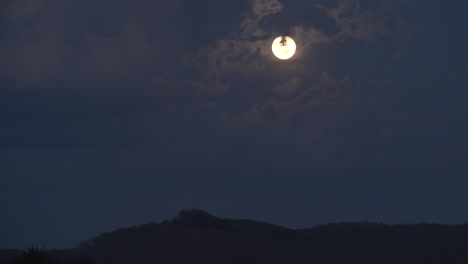 Un-Lapso-De-Tiempo-De-Día-A-Noche-De-Primavera-De-Una-Salida-De-Luna-Detrás-De-Nubes-Hinchadas-En-Las-Colinas-De-Los-Apalaches