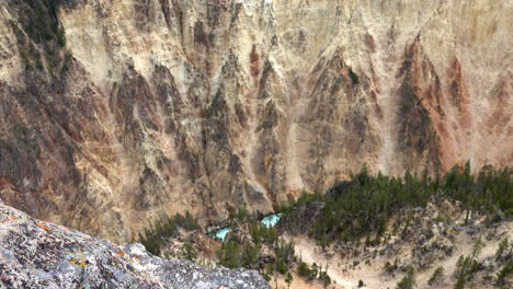 Tilt-down-from-tree-line-across-canyon-wall-to-zoom-in-on-river-in-the-Grand-Canyon-of-Yellowstone